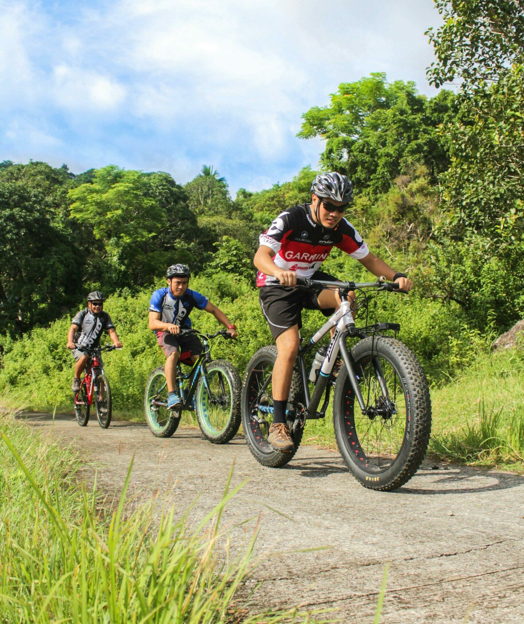 Three Men Riding on Bicycles