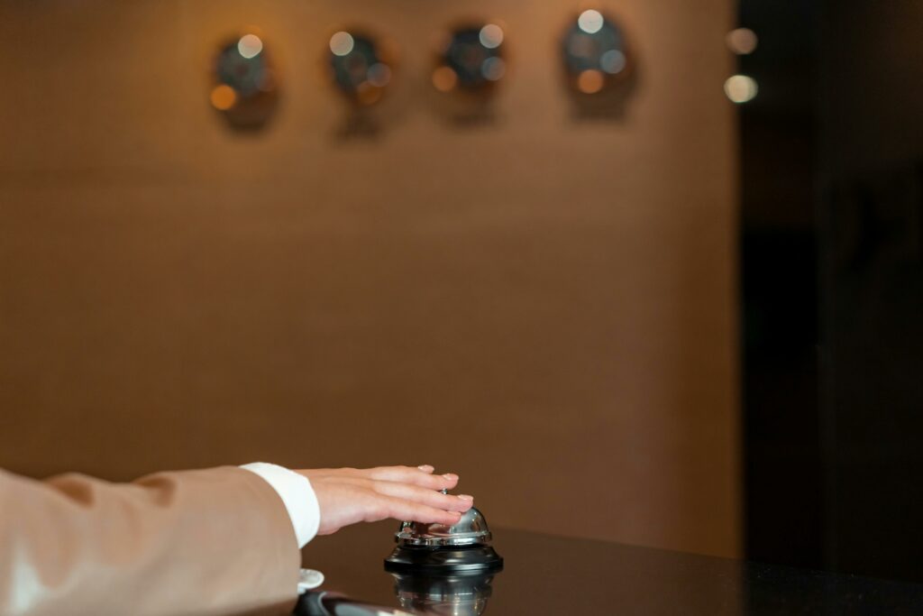 Photo of a Person's Hand Pressing a Bell