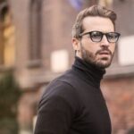 Man Standing Near Building White Black Turtleneck Shirt